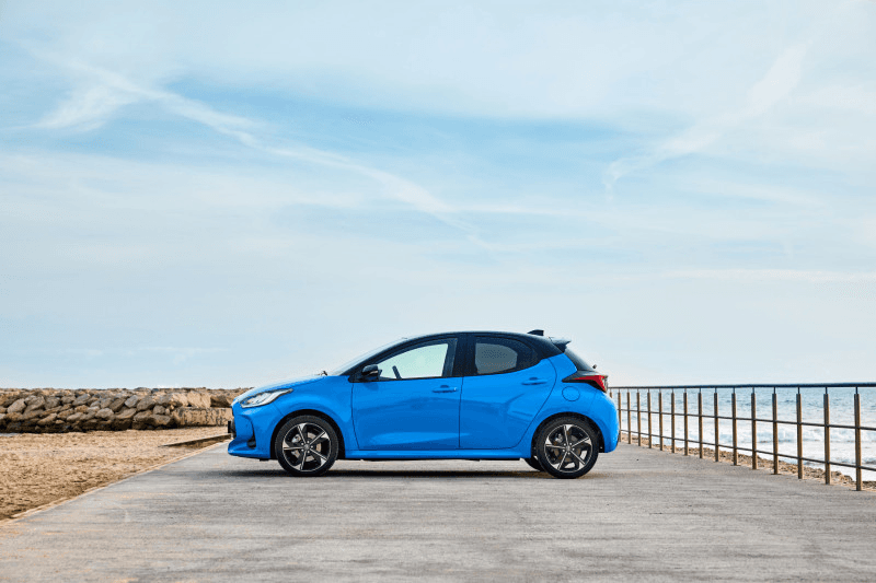 Toyota Yaris in blue at beachfront